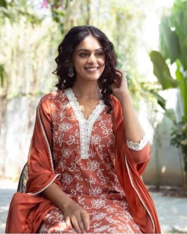 Lady in a rust color stitched suit